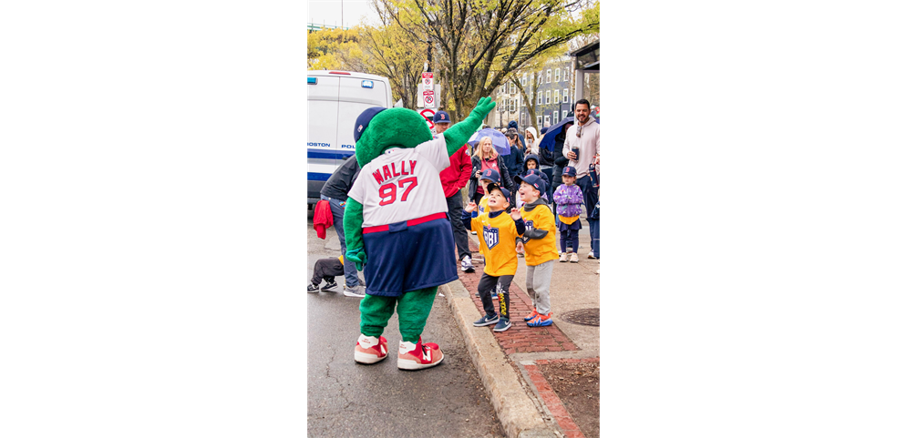 Wally the Green Monster greets players before the opening day parade